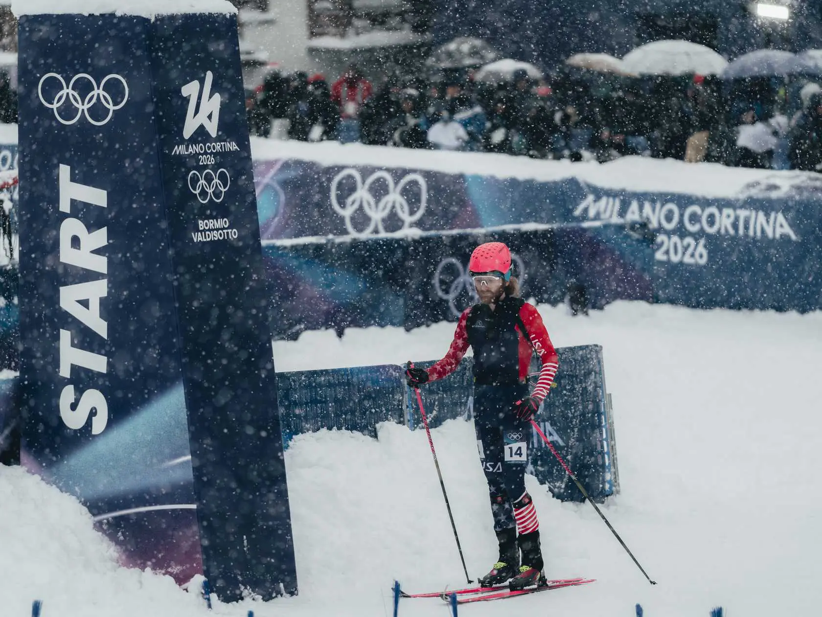 Snow falling on Olympic skier at start