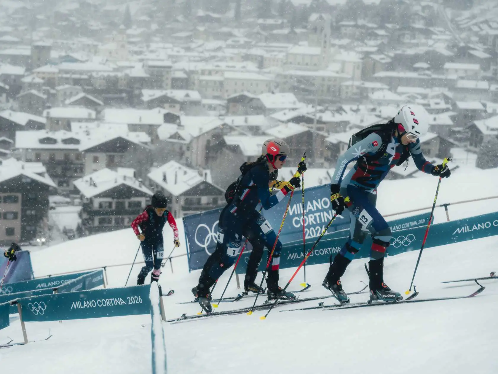 Skimo racers ascending snowy hill