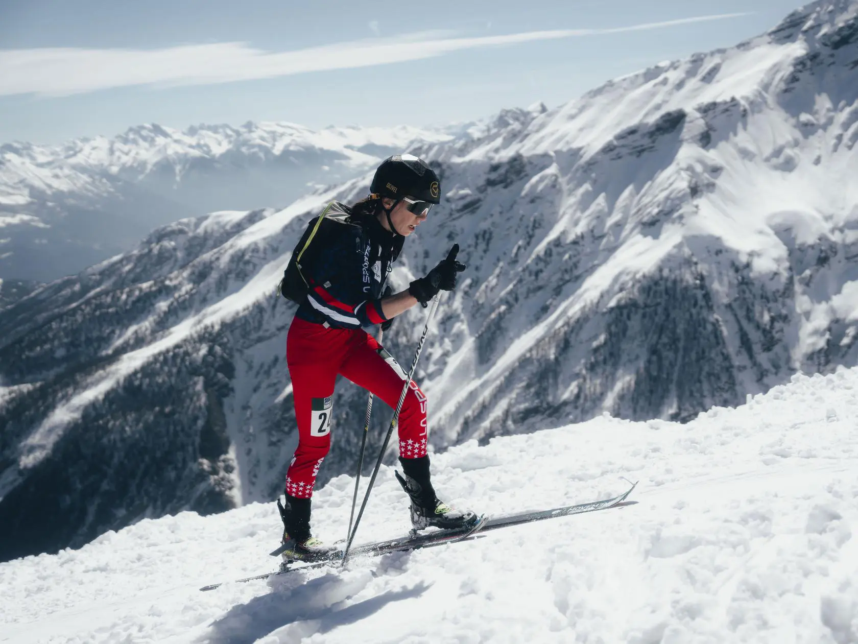 Athlete ascending mountain on skis