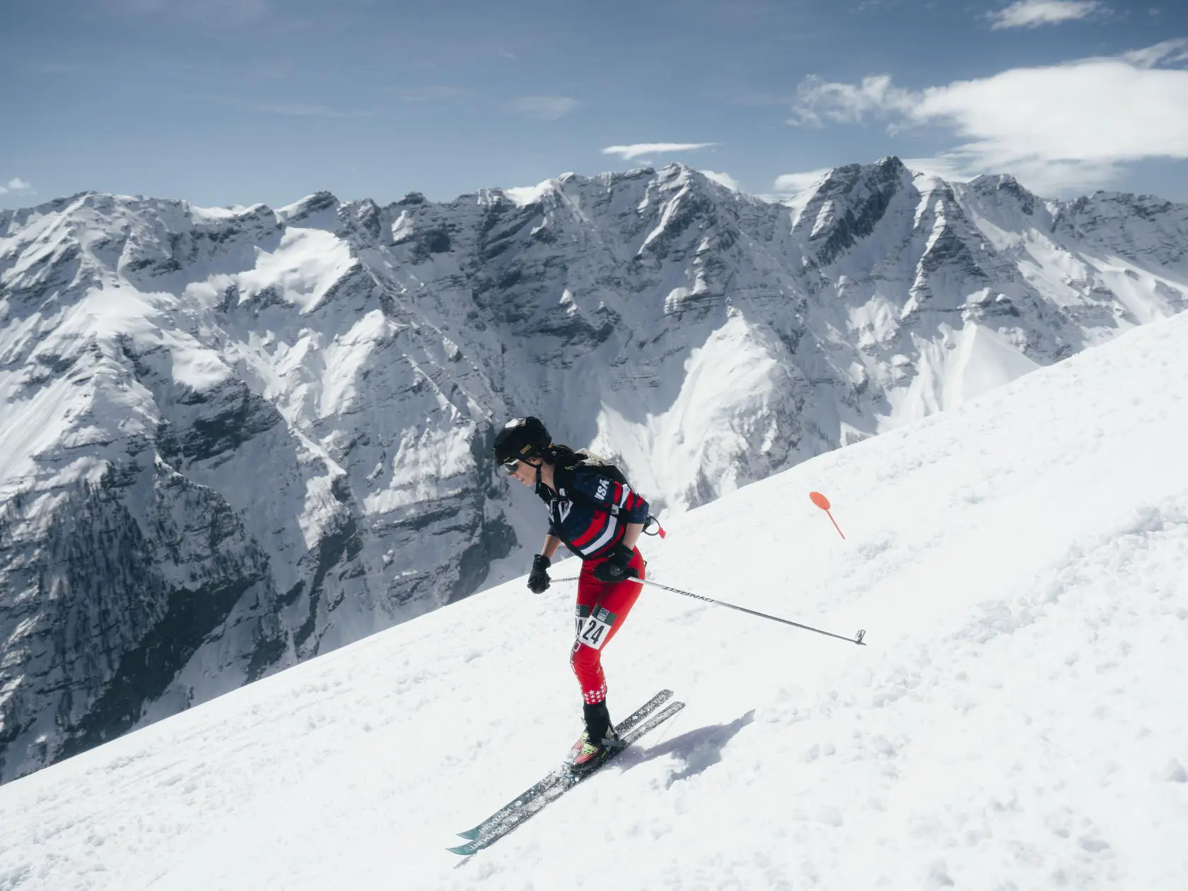 Skier racing down mountain slope