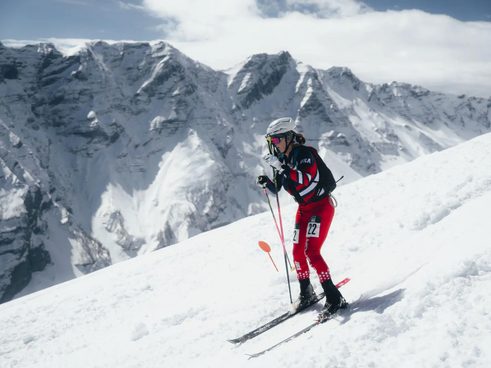 Skier in red USA suit on snowy slope