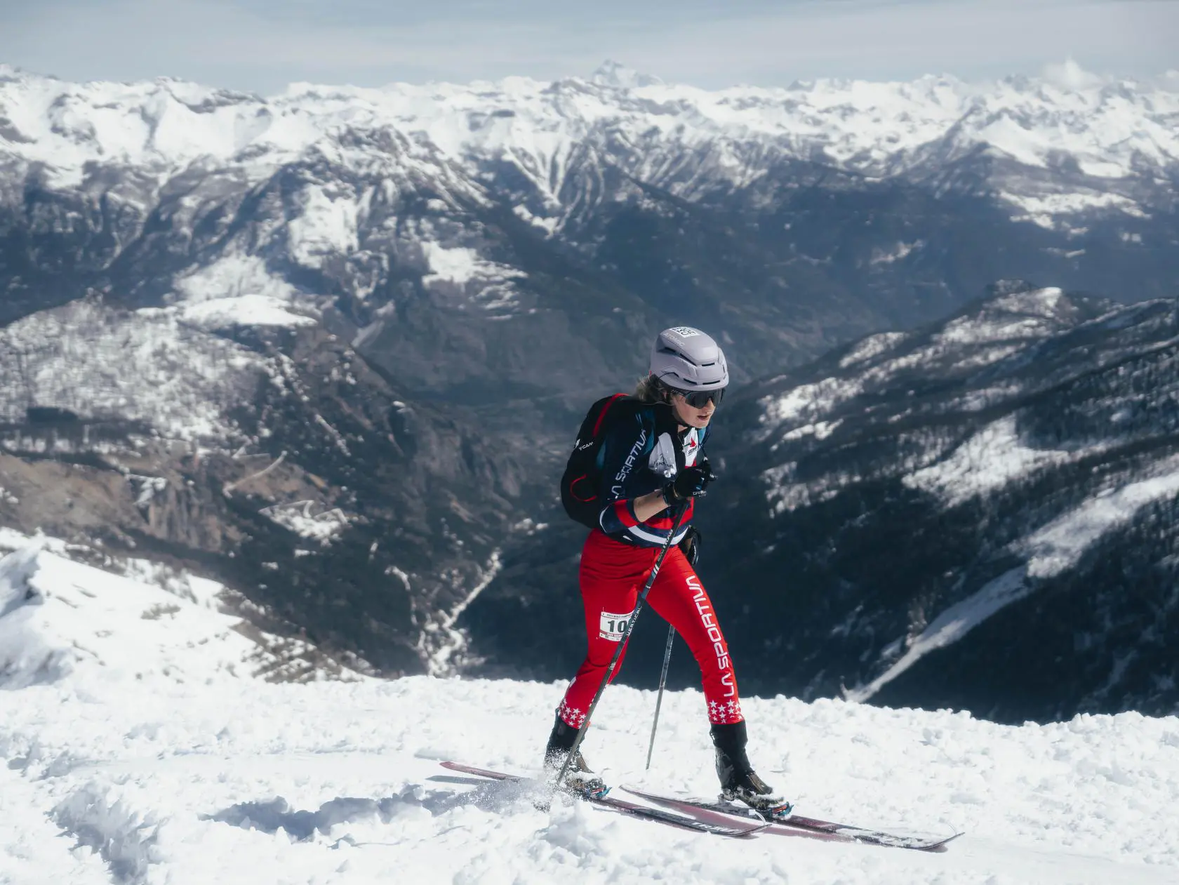 Skier in red suit on snowy peak