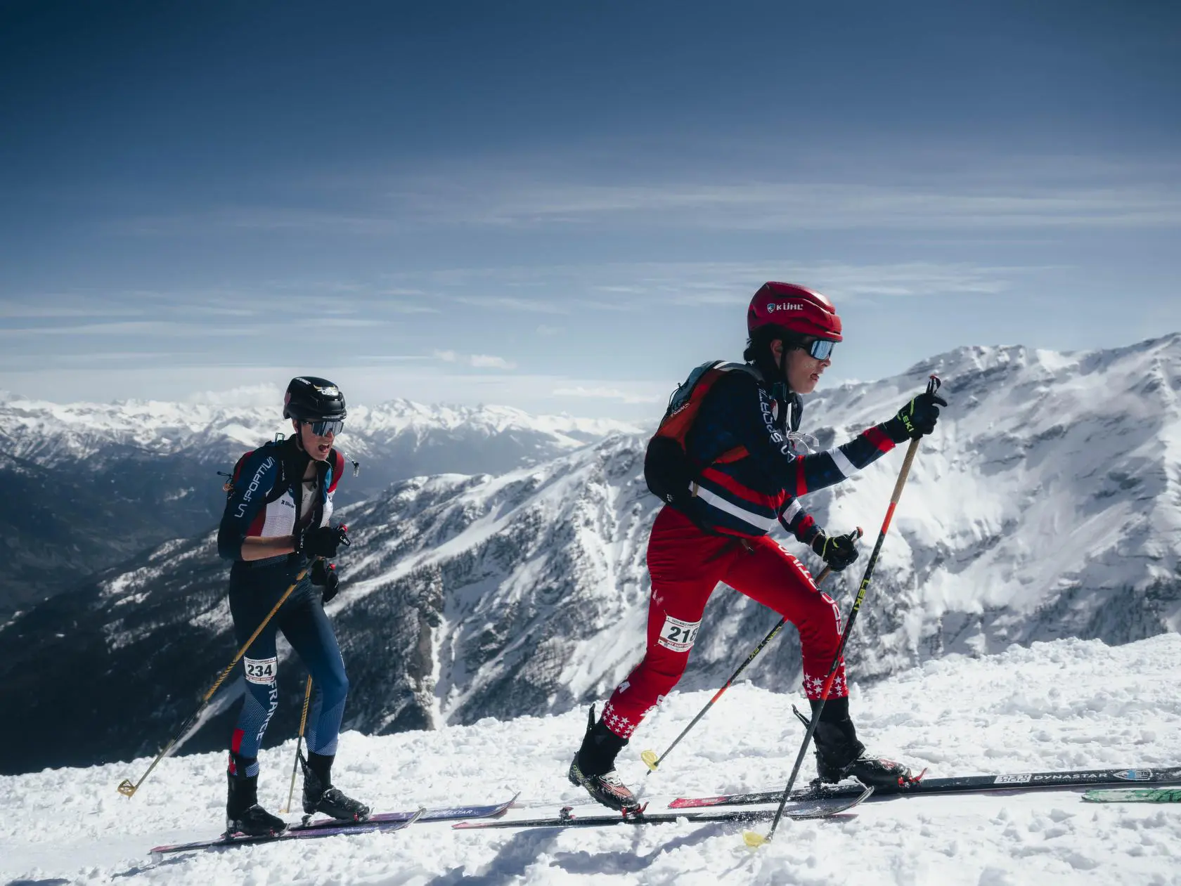 Two skiers climbing snowy mountain range
