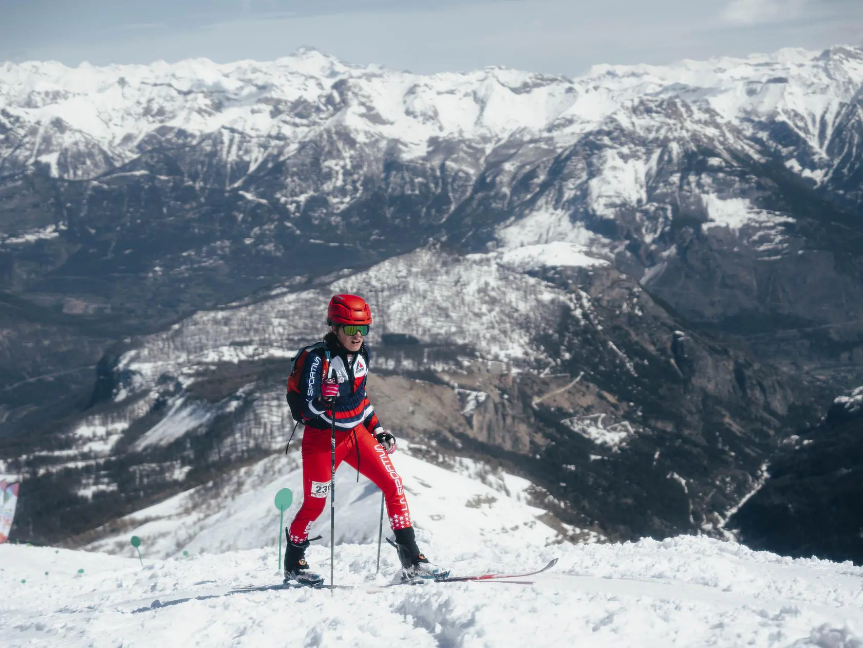 Skier in red suit on snowy mountain