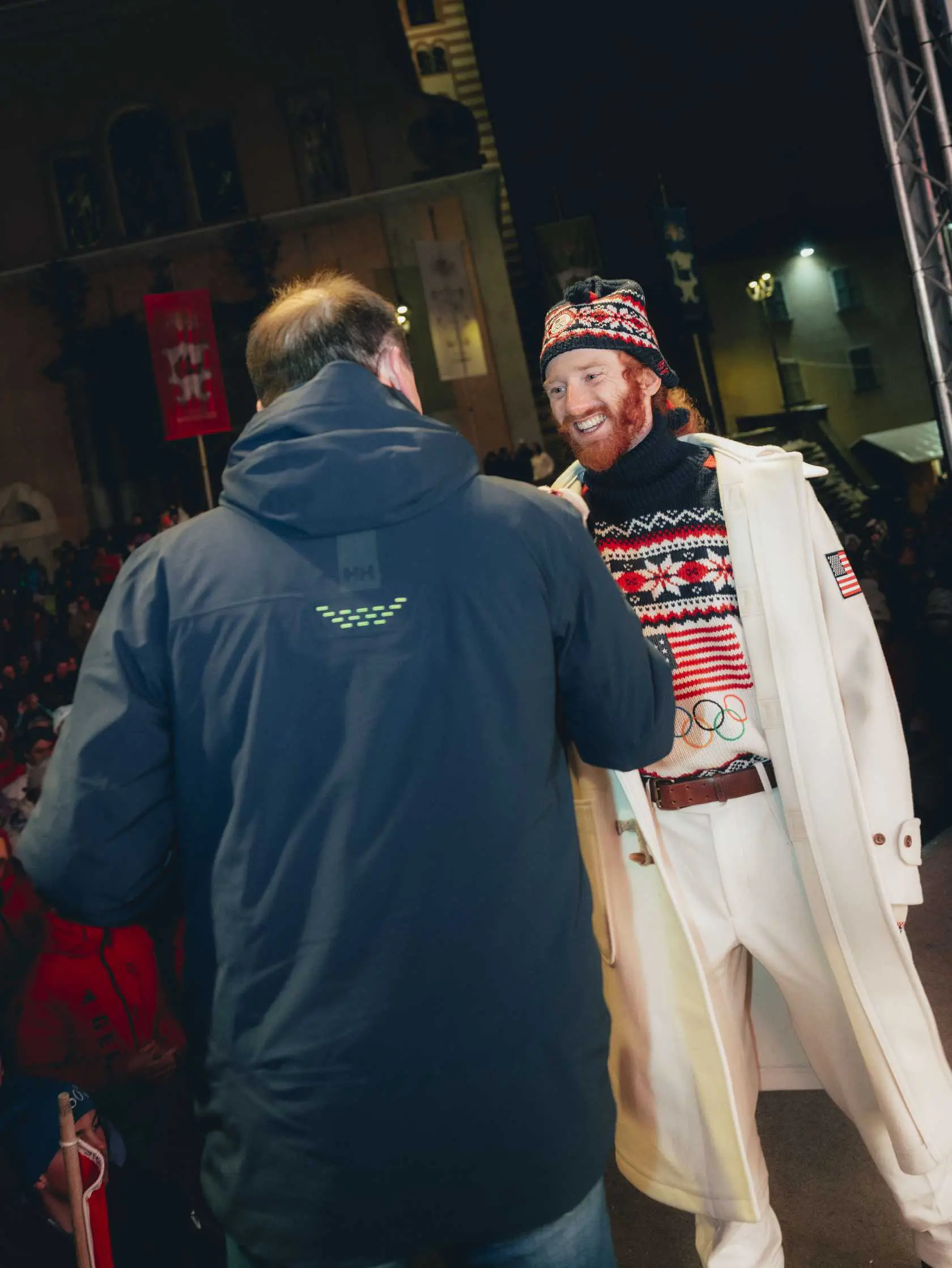 Red-bearded man in Olympic sweater smiling