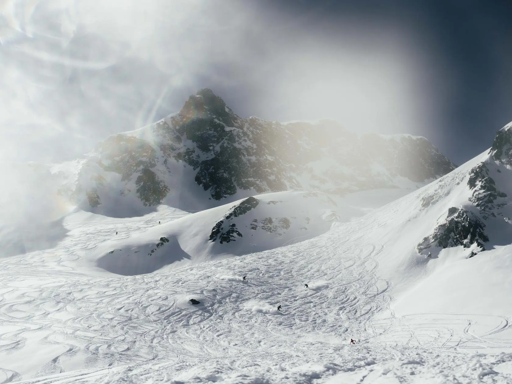 Skiers on snowy mountain slope