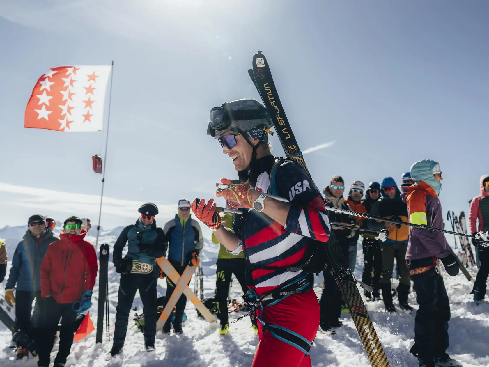 Ski mountaineer on snowy mountain with USA flag
