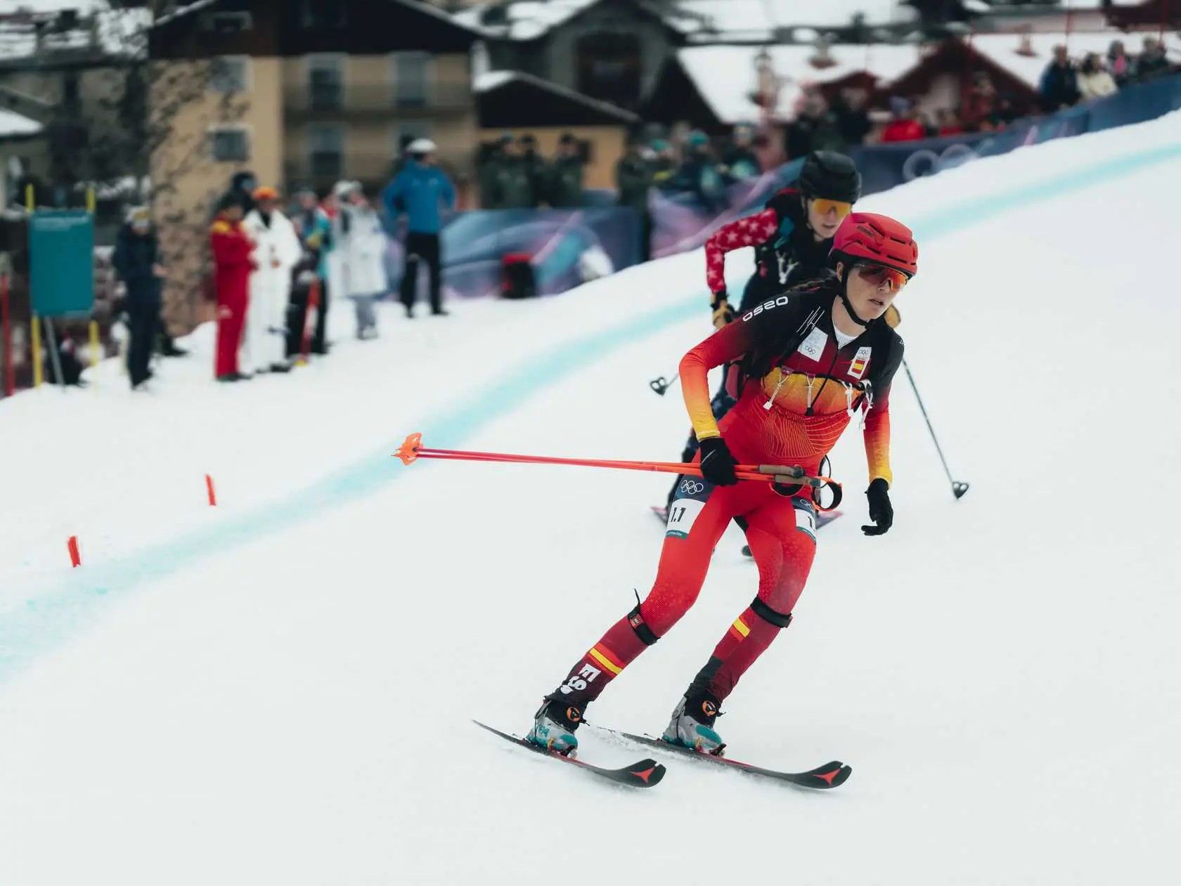 Female ski mountaineer racing downhill