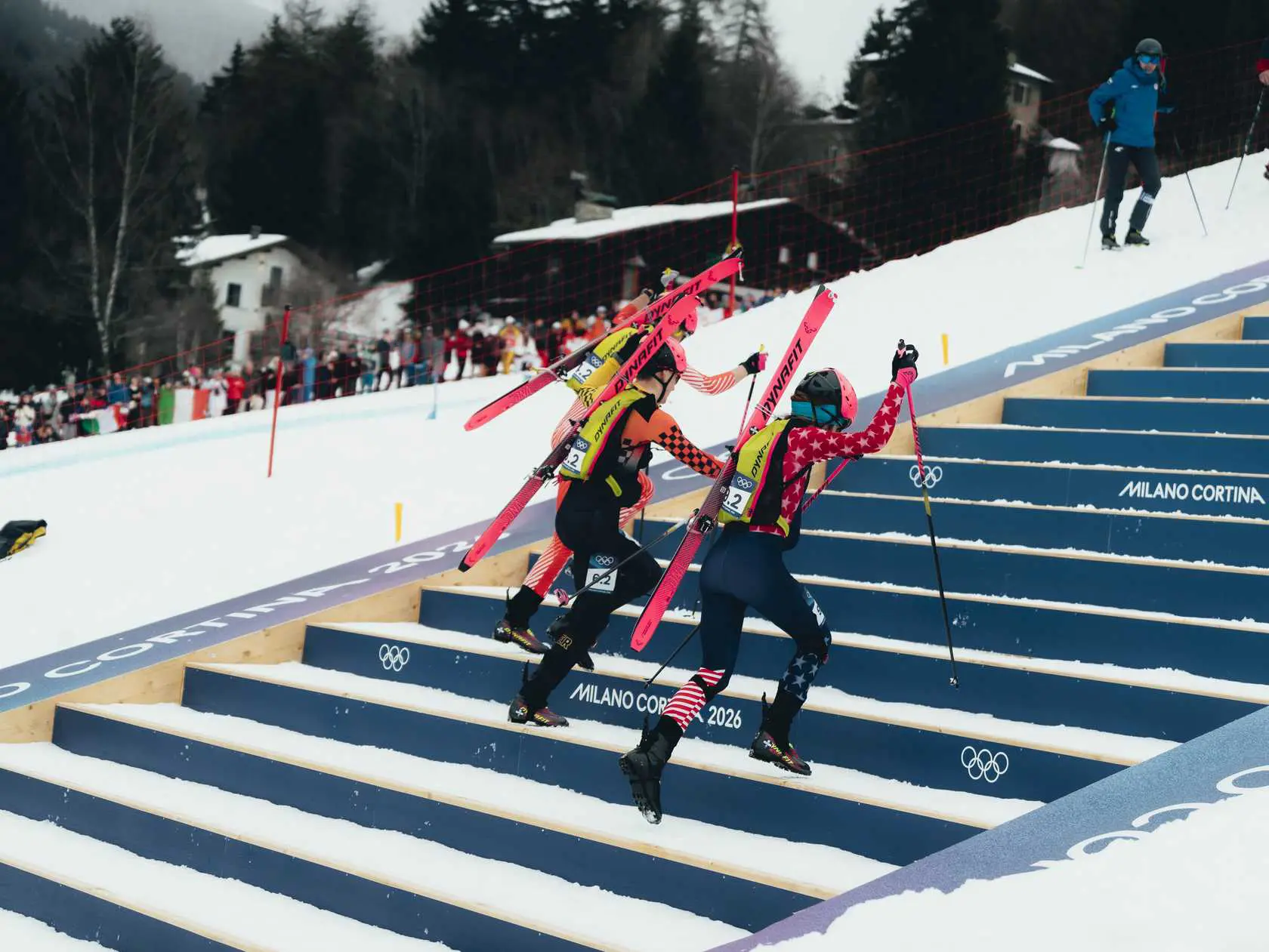 Athletes climbing snowy stairs