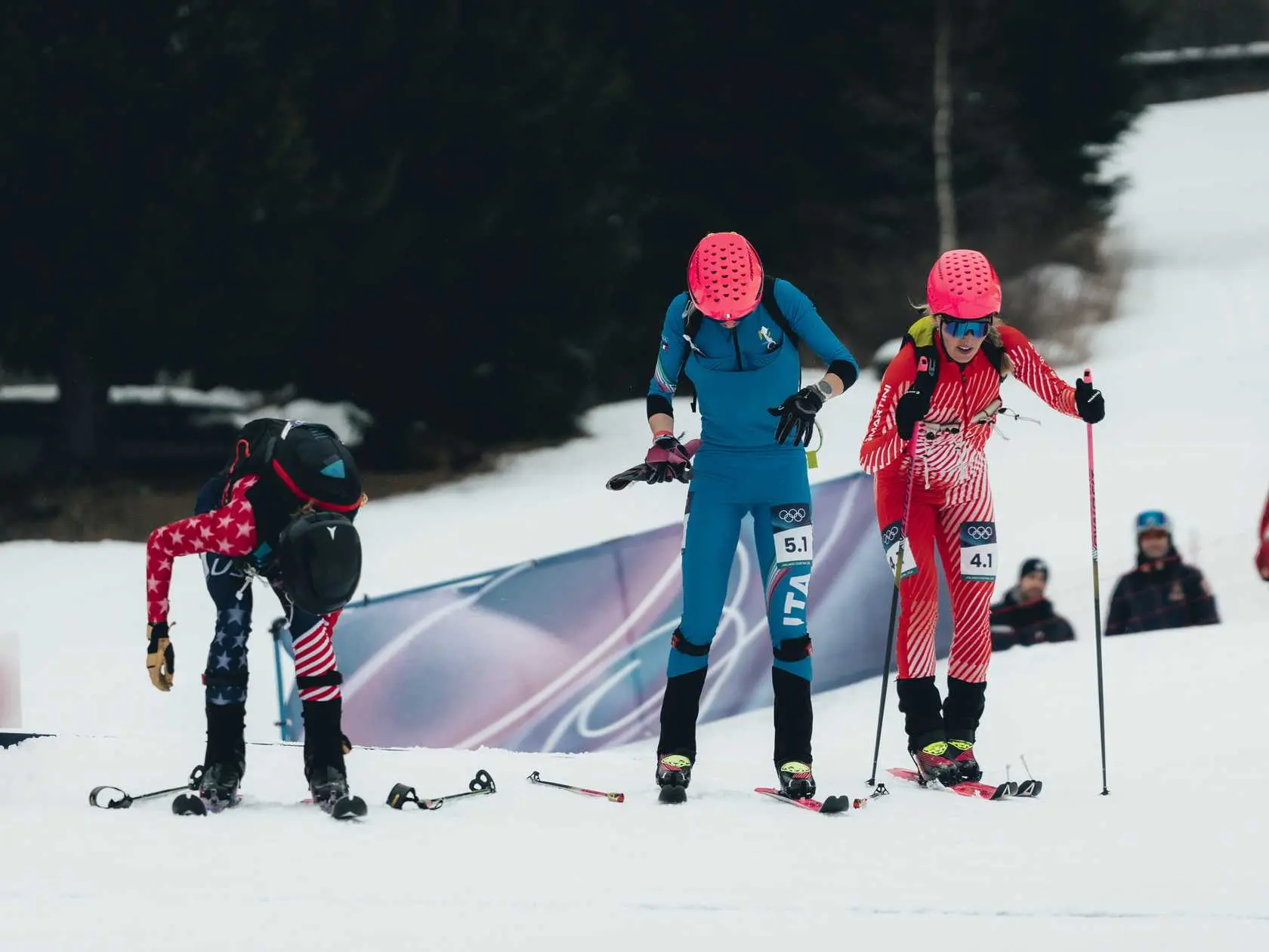 Skimo racers adjusting gear before competition