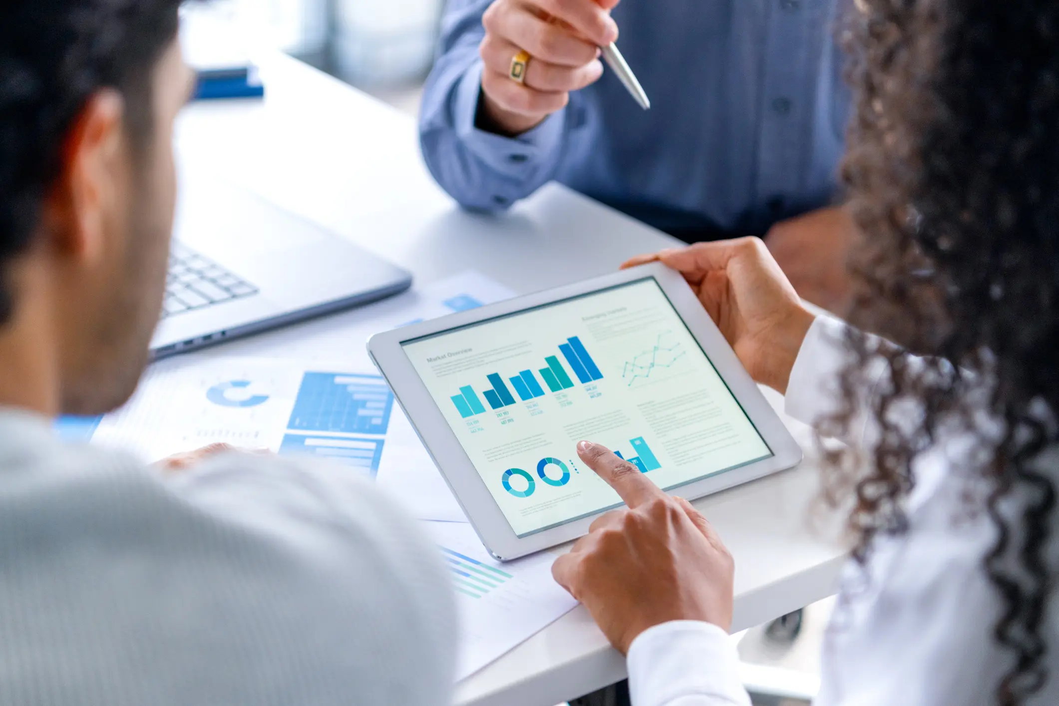 Business team analyzing data on tablet