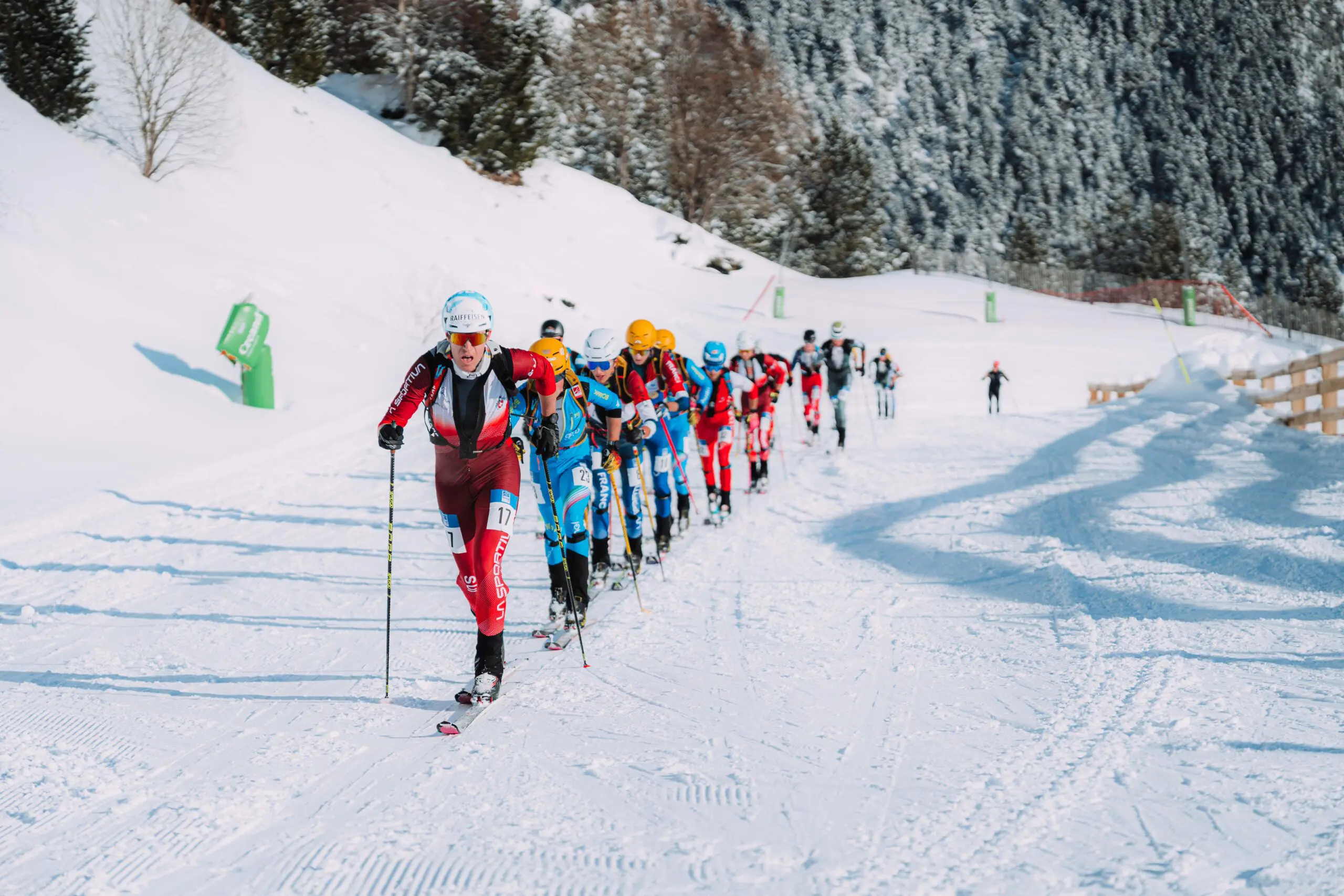 Skiers climbing snowy mountain