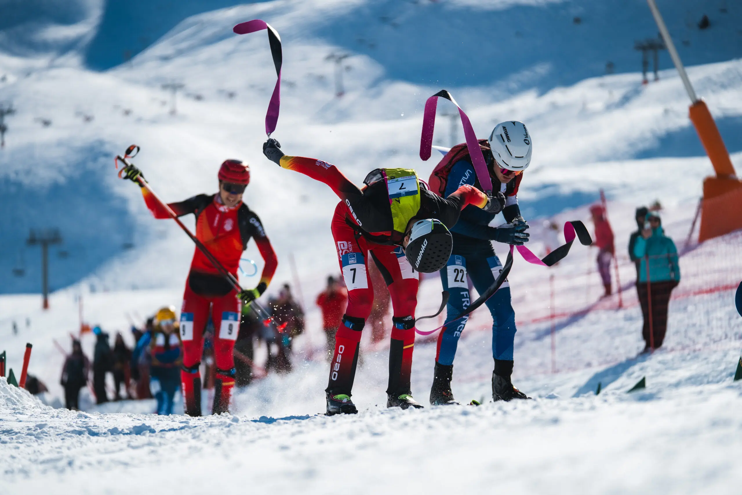 Skimo athletes competing on a sunny slope