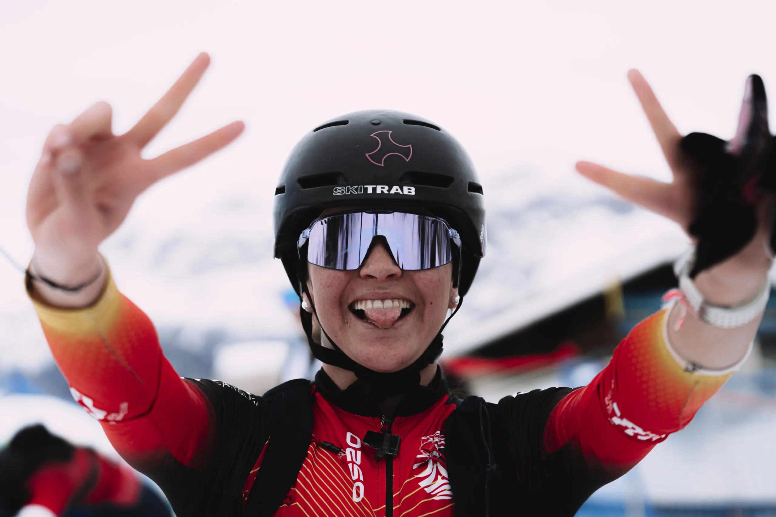 Happy female athlete celebrating with peace signs
