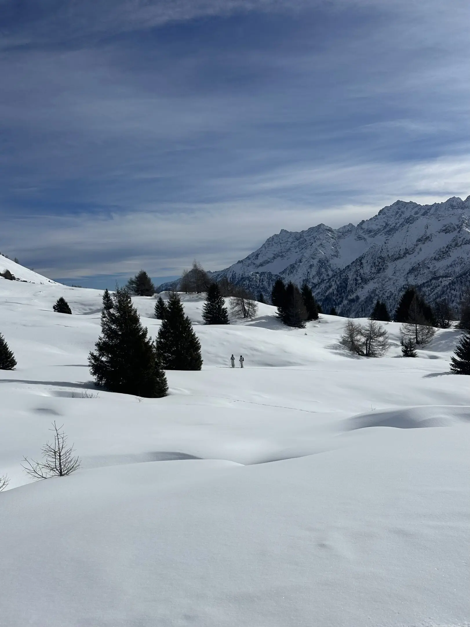Skiers in snowy mountain landscape