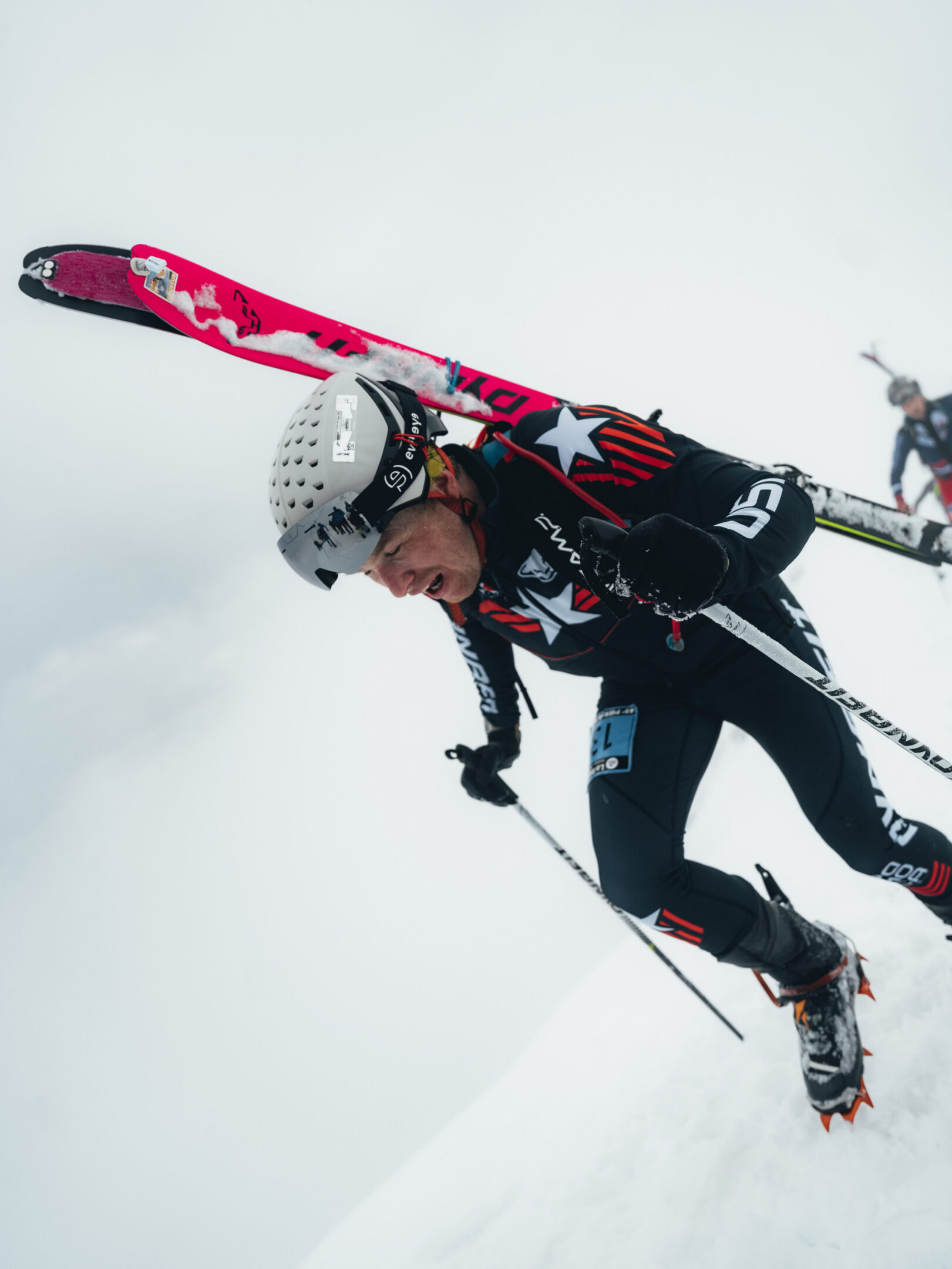 Athlete ski mountaineering uphill in snow