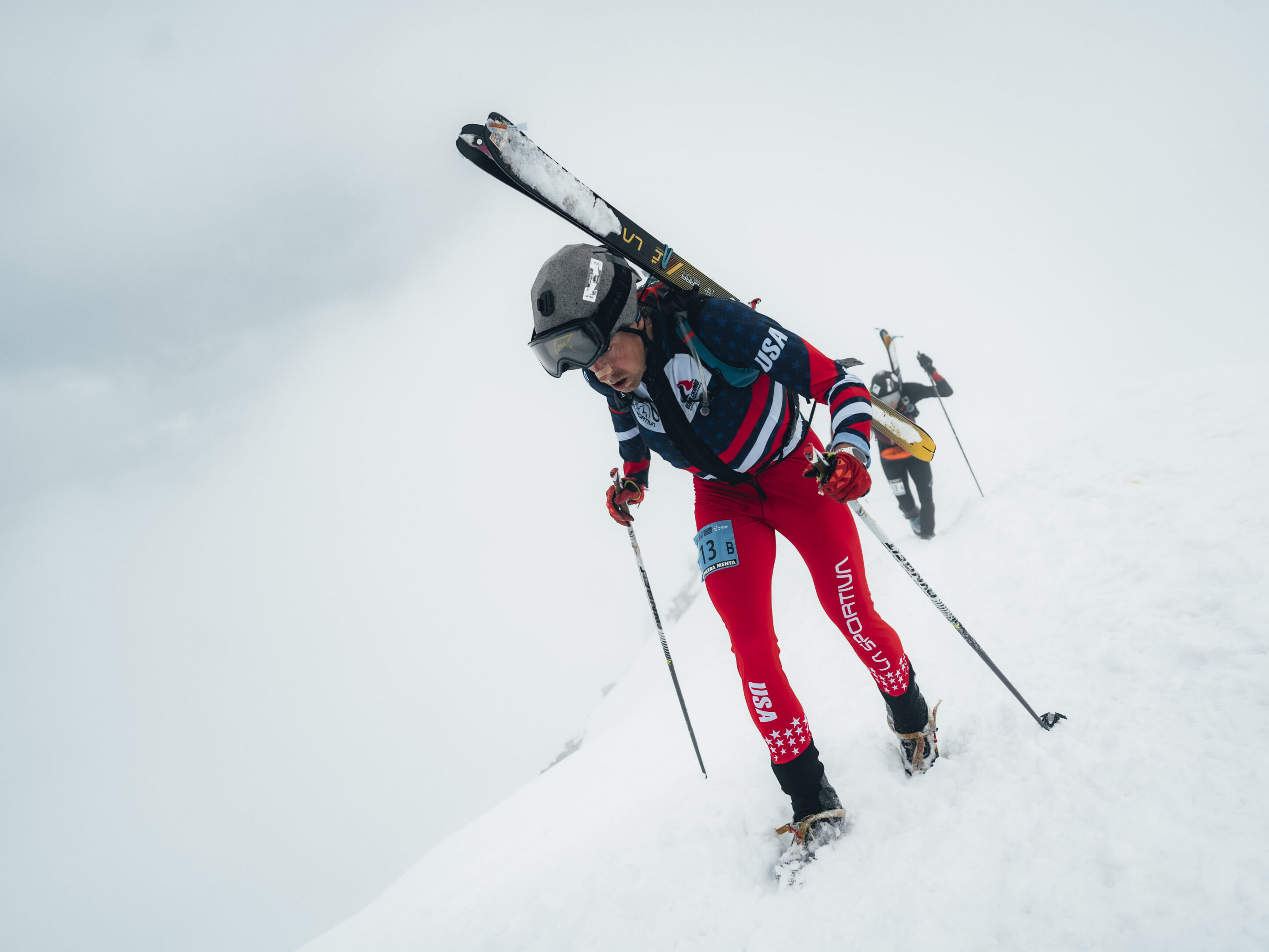 Skier in USA uniform hiking snow