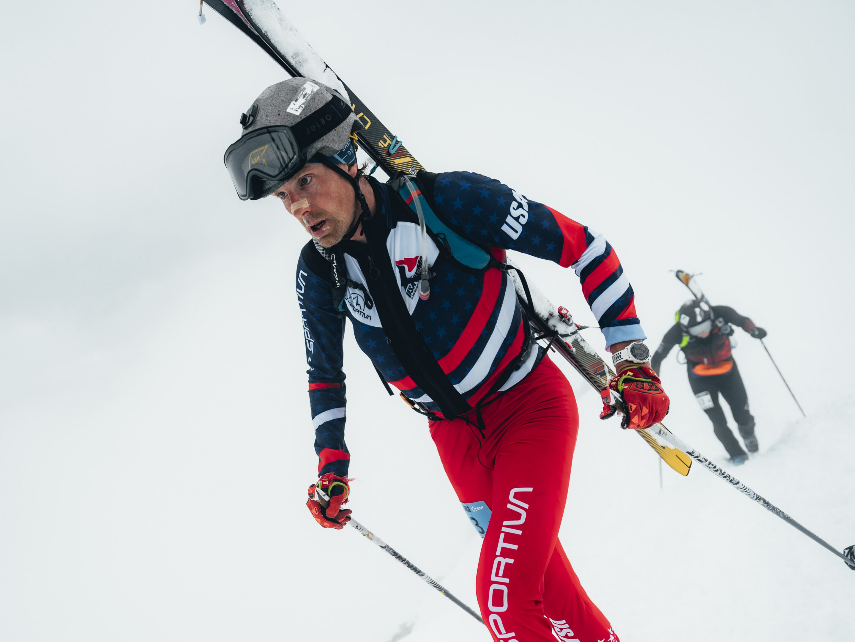 Skier mountaineer climbing snowy mountain