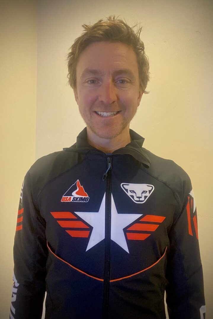 Man standing in front of a wall wearing a jacket with a star on it