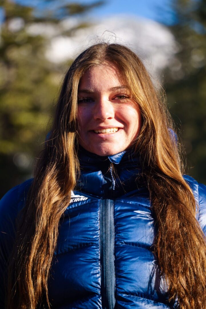 Smiling woman in blue puffer jacket