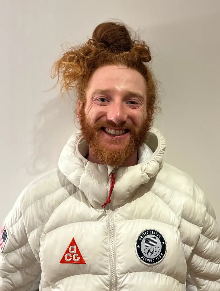 Olympic athlete smiling with a bun hairstyle