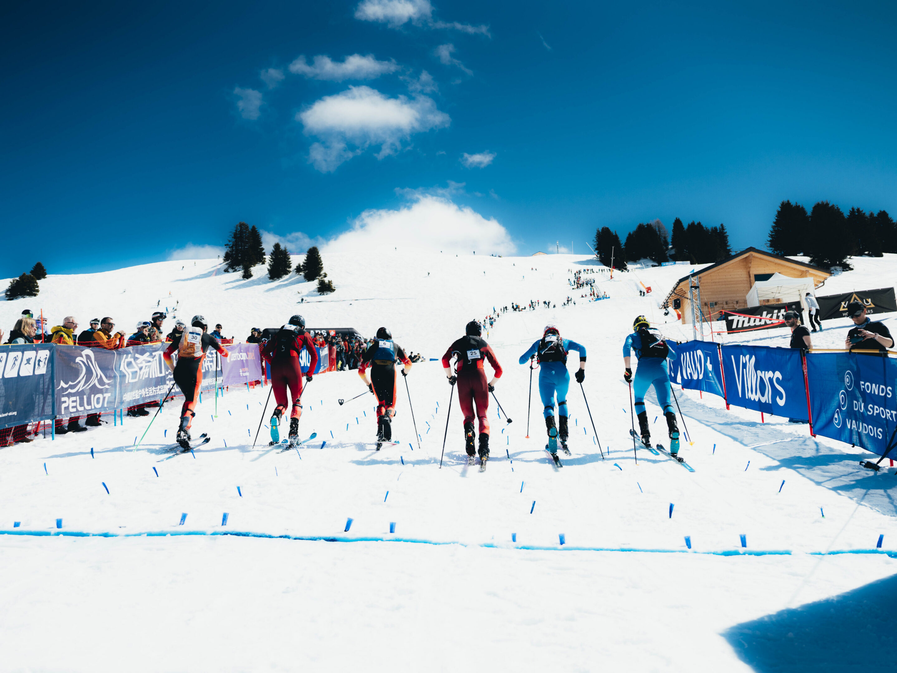 Athletes in ski gear competing on snow slope