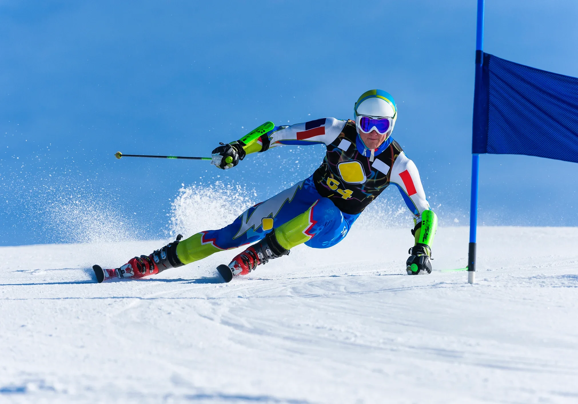 Male athlete skiing down the snowy ski slope
